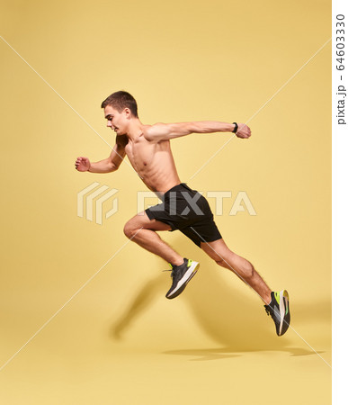 Side view of sportsman running in studio 64603330