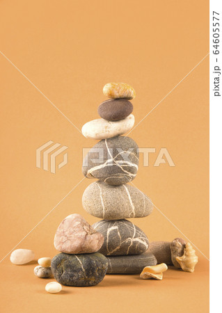 Tower of sea natural stones on a brown background. 64605577
