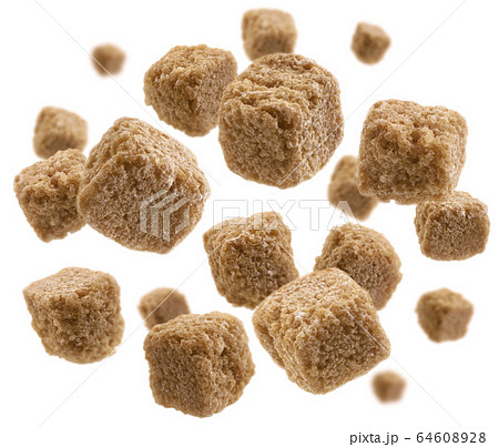 Brown cane sugar levitates on a white background Brown cane sugar levitates on a white background 64608928
