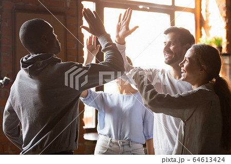 Happy diverse friends giving high five engaged in multicultural friendship 64613424