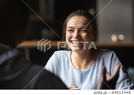 Happy young caucasian woman laughing meeting african boyfriend in cafe Happy young caucasian woman laughing meeting african boyfriend in cafe 64613448