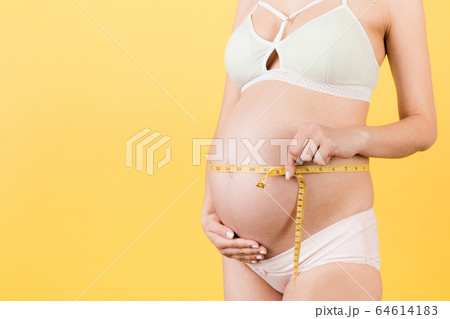 Cropped image of pregnant woman in colorful Cropped image of pregnant woman in colorful 64614183
