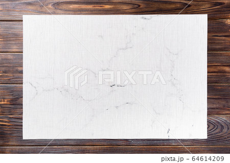 Top view of textile white mat for dinner on wooden 64614209