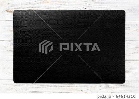 Top view of black place mat for a dish. Wooden 64614210