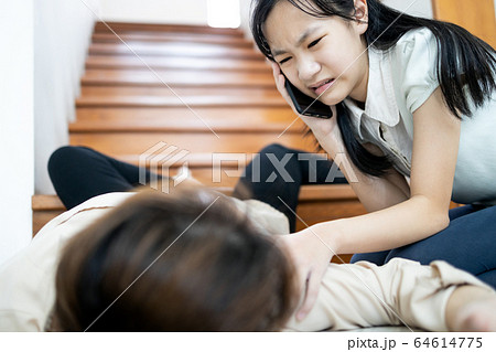 Female in coma on floor after accident,falling down from staircase,sick woman slipped caused by unconscious,syncope,heart failure,daughter care her mother using the phone to call for help to emergency 64614775