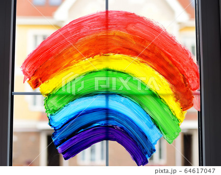 Drawing of rainbow on home window while quarantine 64617047
