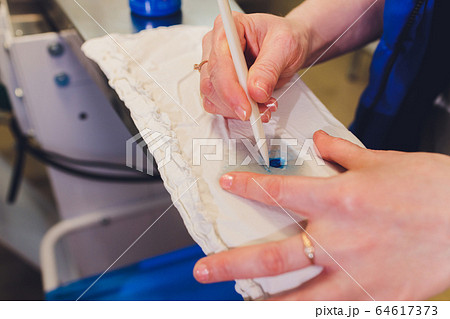 Hand Laundry worker in the process of removing stains by using a special dry-cleaning. Hand Laundry worker in the process of removing stains by using a special dry-cleaning. 64617373