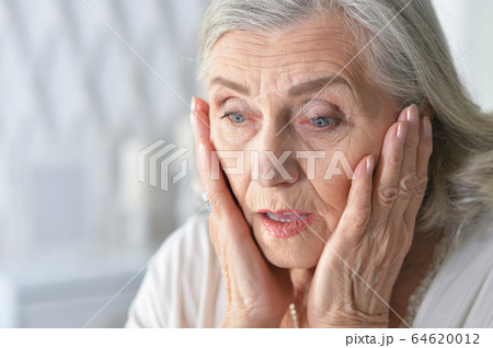Close up portrait of sad ill senior woman Close up portrait of sad ill senior woman 64620012