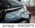 Closeup of a car headlight. Headlight of an expensive new car at a car dealership. 64620076