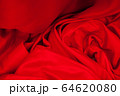 Close-up of folds of red fabric. Rolled up rag 64620080