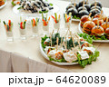 Catering, buffet at the event with various snacks. 64620089