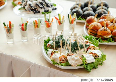 Catering, buffet at the event with various snacks. Catering, buffet at the event with various snacks. 64620089