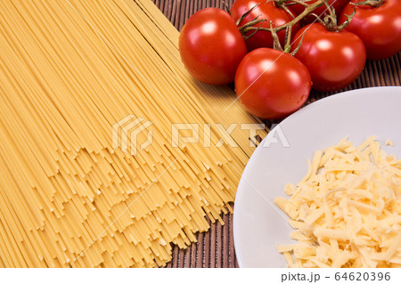 still life with dry spaghetti, tomatoes and grated still life with dry spaghetti, tomatoes and grated 64620396