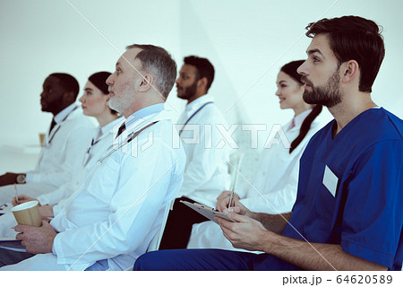 Medical team listening lecture in conference room Medical team listening lecture in conference room 64620589