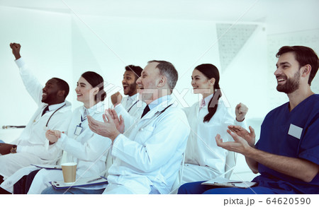 Cheerful doctors applauding during conference in clinic Cheerful doctors applauding during conference in clinic 64620590