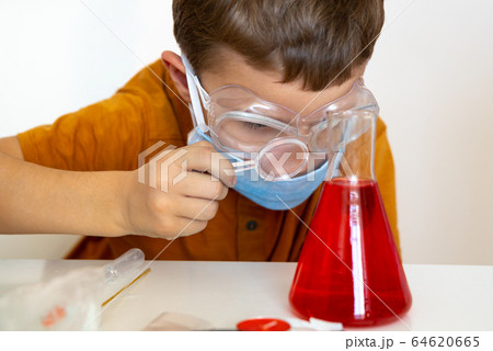 Focused photo on little male that looking at jar Focused photo on little male that looking at jar 64620665