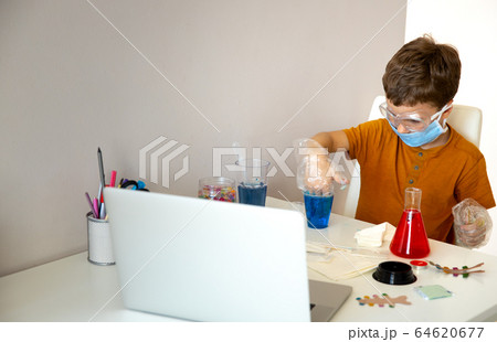Concentrated little schoolboy playing alone at home 64620677