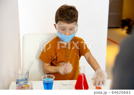 Kind little boy playing at home with water Kind little boy playing at home with water 64620683