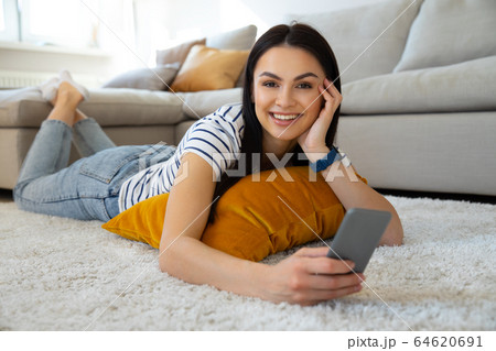 Charming young brunette looking straight at camera Charming young brunette looking straight at camera 64620691