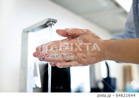 Female washing hands with soap at home 64621644