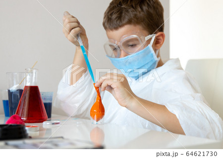 Little boy using home laboratory in free time Little boy using home laboratory in free time 64621730