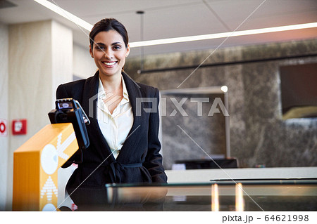 Beautiful lady making contactless payment at airport Beautiful lady making contactless payment at airport 64621998