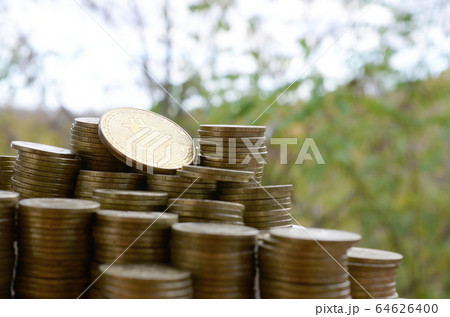 Big amount of bitcoin stacks on blurred green Big amount of bitcoin stacks on blurred green 64626400