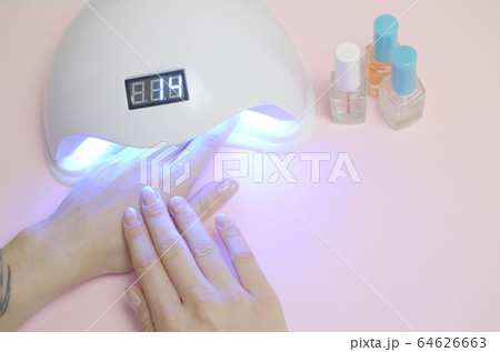 Hands of young woman at manicure procedure close 64626663