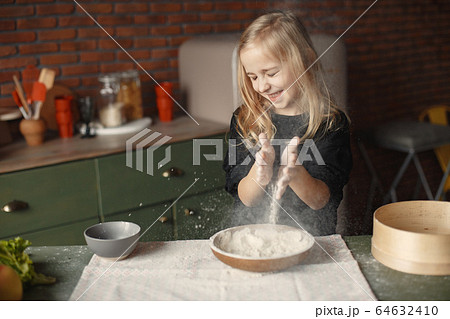 Little girl cook the dough for cookies 64632410