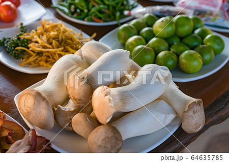 fresh fingerroot slice and green peppercorns chili pepper on table ready to cook fresh fingerroot slice and green peppercorns chili pepper on table ready to cook 64635785