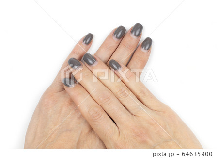 Overgrown shellac nails on female hands on white 64635900