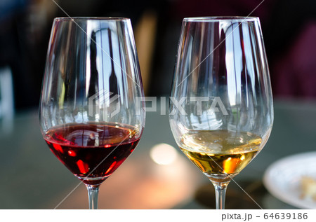 two wine glasses, one red one white 64639186
