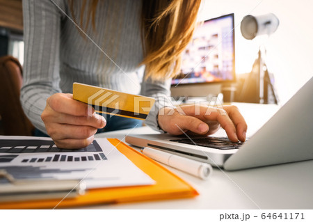 Business woman hands using smartphone and holding credit card with digital layer effect diagram as Online shopping concept Business woman hands using smartphone and holding credit card with digital layer effect diagram as Online shopping concept 64641171