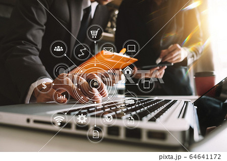 Business documents on office table with smart phone and laptop and two colleagues discussing data in the background in morning light Business documents on office table with smart phone and laptop and two colleagues discussing data in the background in morning light 64641172