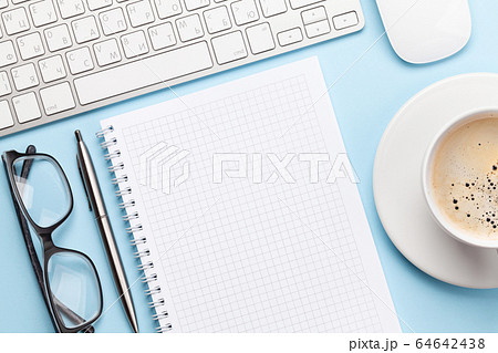 Blue workplace with computer, supplies and coffee 64642438