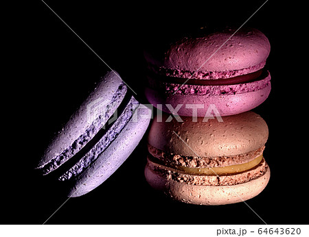 Heap of colorful macaroons darkened 64643620
