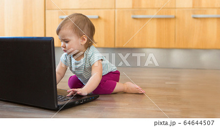 small child plays on computer. The child Prodigy learns the techniques of business Planning, home work, quarantine, self-isolation, protection from coronavirus, virus small child plays on computer. The child Prodigy learns the techniques of business Planning, home work, quarantine, self-isolation, protection from coronavirus, virus 64644507