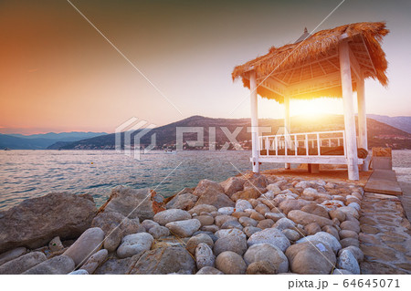 Thatched canopies and awnings on the beach 64645071