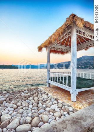 Thatched canopies and awnings on the beach Thatched canopies and awnings on the beach 64645080
