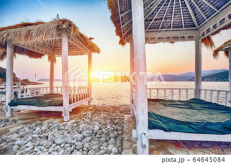 Thatched canopies and awnings on the beach Thatched canopies and awnings on the beach 64645084