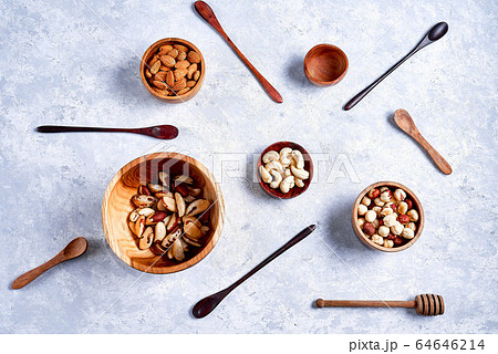 a variety of nuts in wooden bowls pattern on a blue background 64646214