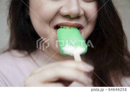 Bitting ice cream, close up shot. 64646258