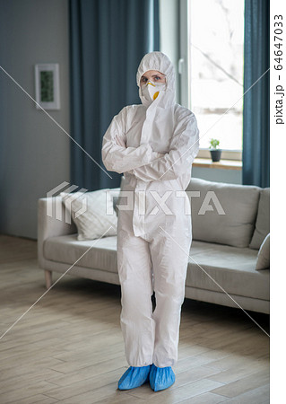 Woman in white workwear and protective eyeglasses looking ready to work 64647033
