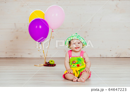 little girl sitting in the Studio with balls little girl sitting in the Studio with balls 64647223