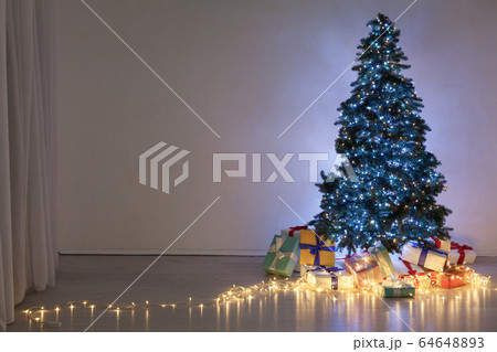 Christmas tree with lights garlands gifts decor of the house new year 64648893