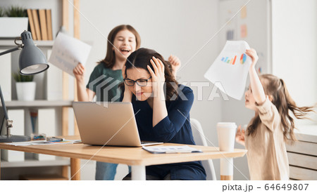 Woman working on a laptop. 64649807