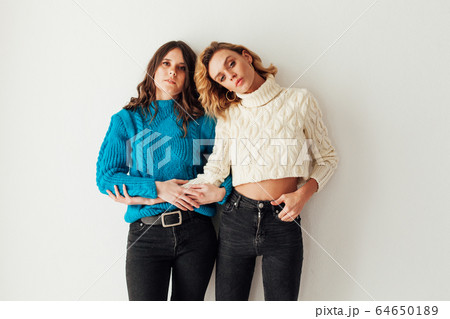 Two beautiful fashionable female girlfriends blonde and brunette Two beautiful fashionable female girlfriends blonde and brunette 64650189