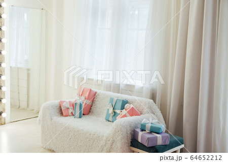 white sofa with birthday gifts in the interior of the white room white sofa with birthday gifts in the interior of the white room 64652212