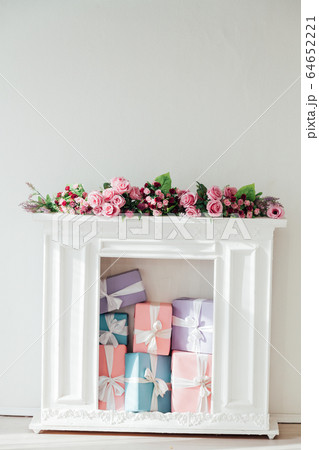 fireplace with flowers in the interior of the white room fireplace with flowers in the interior of the white room 64652221