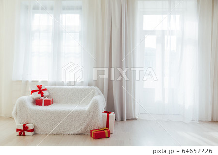 white sofa with birthday gifts in the interior of the white room white sofa with birthday gifts in the interior of the white room 64652226